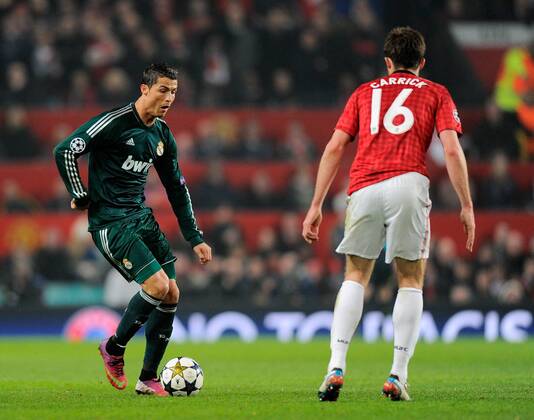 Cristiano Ronaldo of Real Madrid faces Michael Carrick of Manchester United - UEFA CHAMPIONS LEAGUE - ROUND OF 16 - Manchester Utd vs Real Madrid - Old Trafford Stadium - Manchester - 05 03 13 - Picture Simon Bellis Sportimage- EDITORIAL USE ONLY. No use with unauthorised audio, video, data, fixture lists, club league logos or live services. Online in-match use limited to 120 images, no video emulation. No use in betting, games or single club league player publications.