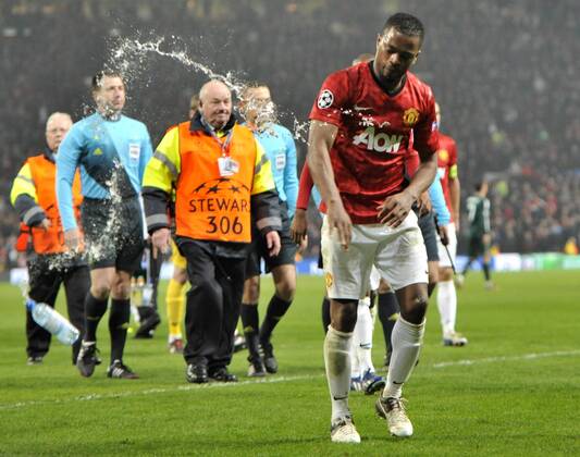 Patrice Evra, angry, throwing a bottle at the end of the match - Old Trafford Stadium - Manchester - UK - 05 03 2013 - Manchester United - Real Madrid - UEFA Champions League 2012 2013 - Round of 16 - Second Leg Match. 