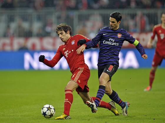 13.03.2013, Fussball Champions League Achtelfinale Rückspiel: FC Bayern München - FC Arsenal London, In der Allianz-Arena München. v.l. Javi Martinez (FC Bayern) gegen Mikel Arteta (Arsenal London)