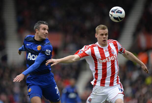Robin van Persie of Manchester United ManU tussles with Ryan Shawcross of Stoke City - Barclays Premier League - Stoke City vs Manchester Utd - Britannia Stadium - Stoke - England - 14 04 13 - EDITORIAL USE ONLY. No use with unauthorised audio, video, data, fixture lists, club league logos or live services. Online in-match use limited to 120 images, no video emulation. No use in betting, games or single club league player publications.