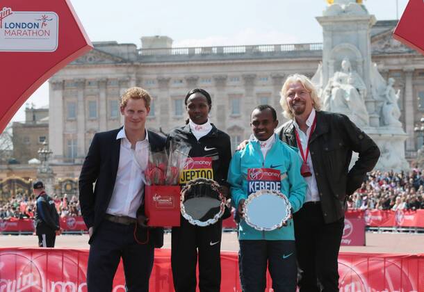 HRH Prince Harry and Virgin CEO Sir Richard Branson stand side by side with the Men and Womens 2013 London Marathon winners Kenya s Priscah Jeptoo and Ethiopia s Tsegaye Kebede at the 2013 London Marathon in London on April 21 2013.  LON2013042113