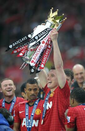 Phil Jones of Manchester United lifts the Premier League trophy - Barclays Premier League - Manchester United ManU - Old Trafford Stadium - Manchester - England - 12 05 13 - EDITORIAL USE ONLY. No use with unauthorised audio, video, data, fixture lists, club league logos or live services. Online in-match use limited to 120 images, no video emulation. No use in betting, games or single club league player publications.
