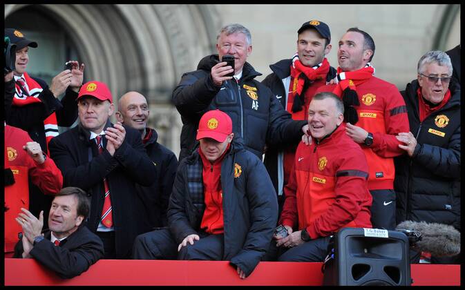 Sir Alex Ferguson takes a picture on his Mobile phone of the fans in Albert Square, Manchester, As Manchester United celebrate winning their 20th league title winning the Premier League, Monday May 13, 2013. AndrewxParsonsx xi-Images AJP