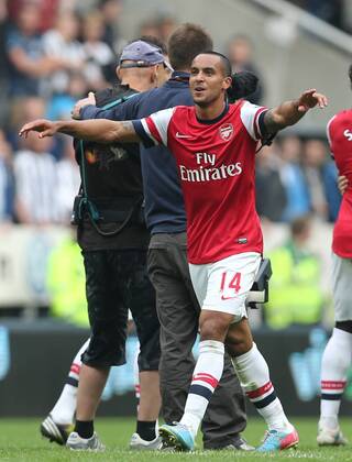Football - English Premiership - Newcastle v Arsenal Arsesnal player Theo Walcott celebrates securing Champions League football during the Newcastle v Arsenal, Barclay s Premier League football match at St James Park, Newcastle. Colorsport 19th May 2013