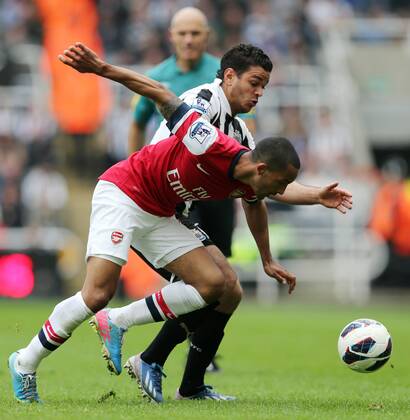 Football - English Premiership - Newcastle v Arsenal Hatem Ben Arfa of Newcastle competes with Theo Walcott of Arsenal during the Newcastle v Arsenal, Barclay s Premier League football match at St James Park, Newcastle. Colorsport 19th May 2013