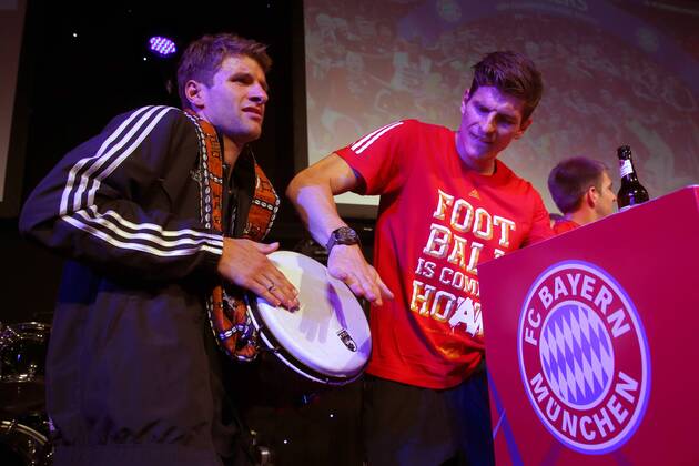 LONDON, ENGLAND - MAY 25: Thomas Mueller (L) of FC Bayern München celebrates with his team mate Mario Gomez on the Bayern München Champions League Finale banquet at Grosvenor House on May 25, 2013 in London, England. Local Caption Thomas Mueller; Mario Gomez