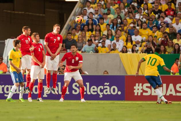 Football - International Friendly - Brazil vs. England Neymar of Brazil sends a free kick around the England wall at the Maracana Stadium, Rio de Janeiro
