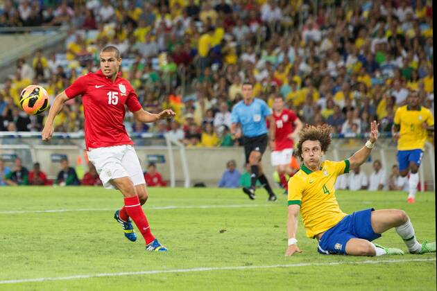 Football - International Friendly - Brazil vs. England David Luiz of Brazil fails to clear a crossed ball but Jack Rodwell of England cannot capitalise at the Maracana Stadium, Rio de Janeiro