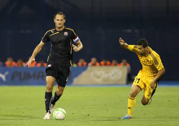 Zagreb, 30.7.2013. - UEFA Champions League 2013 2014, Third Qualifying Round, Stadium Maksimir. GNK Dinamo (blue) - FC Sheriff (yellow). Josip Simunic vs Ricardo Cavalcante Mendes GNK Dinamo - FC Sheriff