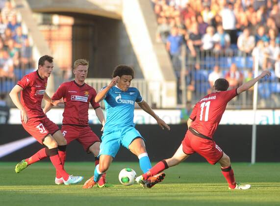 ITAR-TASS: ST PETERSBURG, RUSSIA. AUGUST 7, 2013. FC Nordsjaelland s Oliver Thychosen, Anders Christiansen, Morten Nordstrand (L-R in red) and Zenit s Axel Witsel (in blue) in action in the second leg of their UEFA Champions League third qualifying round football match at Petrovsky Stadium. Zenit won the game 5-0.  premiumd RE124A7D