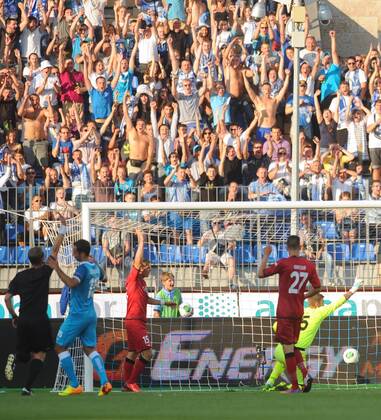 ITAR-TASS: ST PETERSBURG, RUSSIA. AUGUST 7, 2013. Zenit s Roman Shirokov (L in blue) scores a goal past FC Nordsjaelland s goalkeeper Martin Hansen (R in yellow) in the second leg of their UEFA Champions League third qualifying round football match at Petrovsky Stadium. Zenit won the game 5-0.  premiumd RE124A80