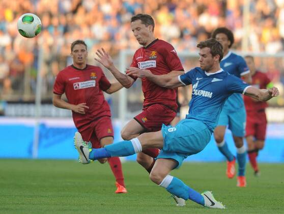ITAR-TASS: ST PETERSBURG, RUSSIA. AUGUST 7, 2013. Zenit s Nicolas Lombaerst (front in blue) kicks the ball in the second leg of their UEFA Champions League third qualifying round football match against FC Nordsjaelland (Denmark) at Petrovsky Stadium. Zenit won the game 5-0.  premiumd RE124A82