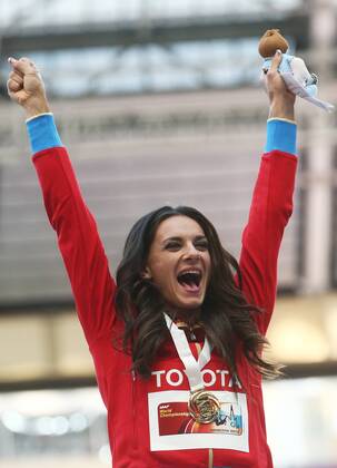 ITAR-TASS: MOSCOW, RUSSIA. AUGUST 15, 2013. Gold medal winner, Russia s Yelena Isinbayeva celebrates during the medal ceremony for the women s pole vault final at Luzhniki on Day 6 of the 14th IAAF World Championships in Athletics.  premiumd RE12571B