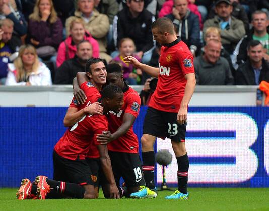 Robin van Persie of Manchester United celebrates scoring the first goal - Barclays Premier League - Swansea City AFC vs Manchester United - Liberty Stadium - Swansea - Wales - 17 08 13 - EDITORIAL USE ONLY. No use with unauthorised audio, video, data, fixture lists, club league logos or live services. Online in-match use limited to 120 images, no video emulation. No use in betting, games or single club league player publications.