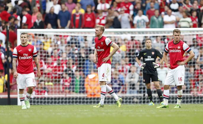 Arsenal s Per Mertesacker looks on dejected after going 3-1 down - FC Arsenal London vs Aston Villa FC - Barclays Premiership - Emirates Stadium - London - England -17 08 2013 - EDITORIAL USE ONLY. No use with unauthorised audio, video, data, fixture lists, club league logos or live services. Online in-match use limited to 120 images, no video emulation. No use in betting, games or single club league player publications.
