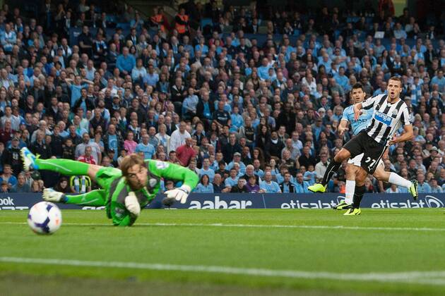 Sergio Aguero of Manchester City scores his sides second goal - Manchester City vs. Newcastle United - Premier League - Etihad Stadium - Manchester - 19 08 2013 Pic Philip Oldham Sportimage EDITORIAL USE ONLY. No use with unauthorised audio, video, data, fixture lists, club league logos or live services. Online in-match use limited to 120 images, no video emulation. No use in betting, games or single club league player publications.