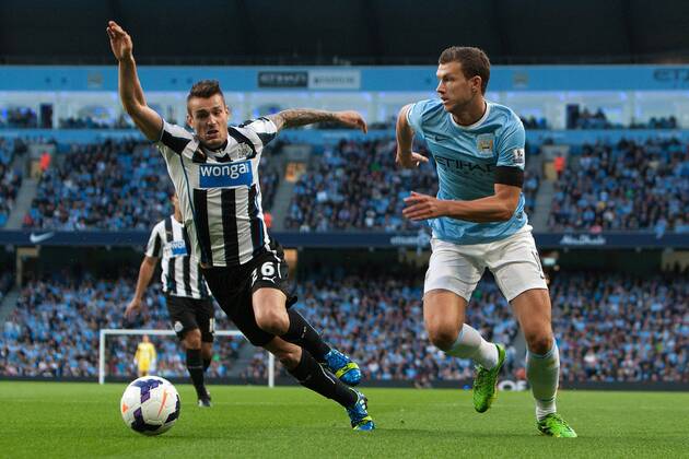 Edin Dzeko of Manchester City breaks past Hatem Ben Arfa of Newcastle United - Manchester City vs. Newcastle United - Premier League - Etihad Stadium - Manchester - 19 08 2013 Pic Philip Oldham Sportimage EDITORIAL USE ONLY. No use with unauthorised audio, video, data, fixture lists, club league logos or live services. Online in-match use limited to 120 images, no video emulation. No use in betting, games or single club league player publications.