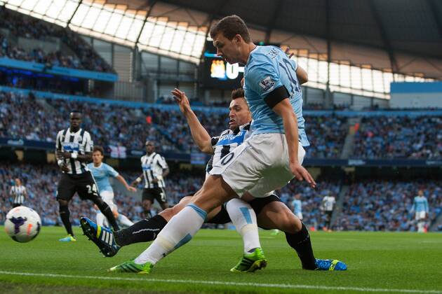 Edin Dzeko of Manchester City breaks past Hatem Ben Arfa of Newcastle United - Manchester City vs. Newcastle United - Premier League - Etihad Stadium - Manchester - 19 08 2013 Pic Philip Oldham Sportimage EDITORIAL USE ONLY. No use with unauthorised audio, video, data, fixture lists, club league logos or live services. Online in-match use limited to 120 images, no video emulation. No use in betting, games or single club league player publications.