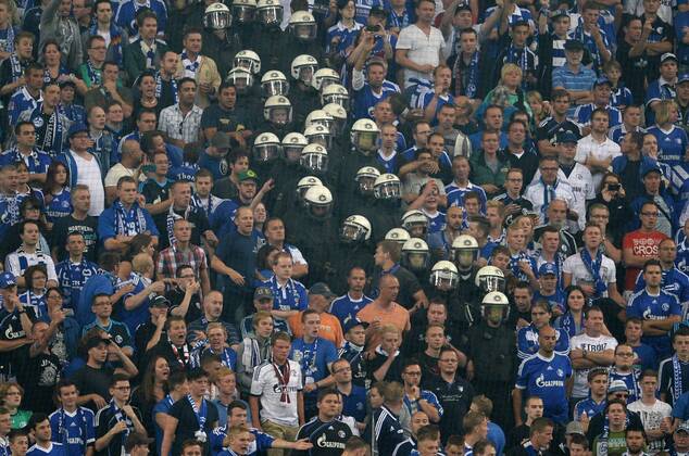 FUSSBALL CHAMPIONS LEAGUE SAISON 2013 2014 PLAY-OFF FC Schalke 04 - Paok Saloniki 21.08.2013 Polizisten stürmen während des Spiels den Schalke Fan Block. 