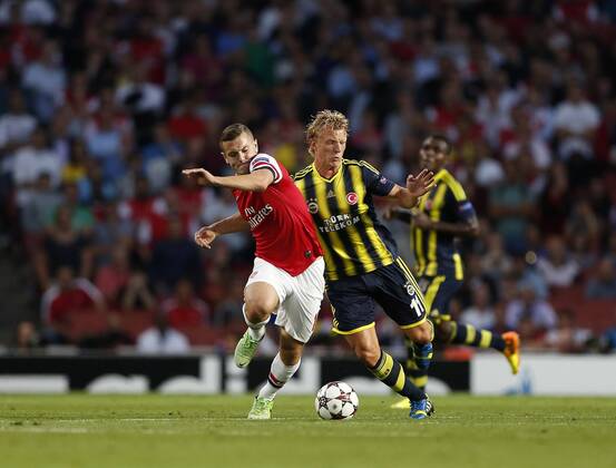 Arsenal s Jack Wilshere tussles with Fenerbahce s Dirk Kuyt Arsenal FC London v Fenerbahce istanbul - UEFA Champions League - Play-off Second Leg - Emirates Stadium - London - England -27 08 2013 - EDITORIAL USE ONLY. No use with unauthorised audio, video, data, fixture lists, club league logos or live services. Online in-match use limited to 120 images, no video emulation. No use in betting, games or single club league player publications.