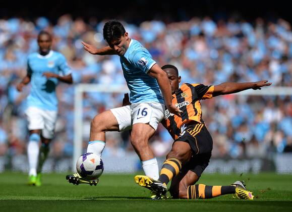 Sergio Kun Agüero of Manchester City is knocked off the ball by Maynor Figueroa of Hull City - Barclays Premier League - Manchester City vs Hull City - Etihad Stadium - Manchester - England - 31 08 13 - EDITORIAL USE ONLY. No use with unauthorised audio, video, data, fixture lists, club league logos or live services. Online in-match use limited to 120 images, no video emulation. No use in betting, games or single club league player publications.