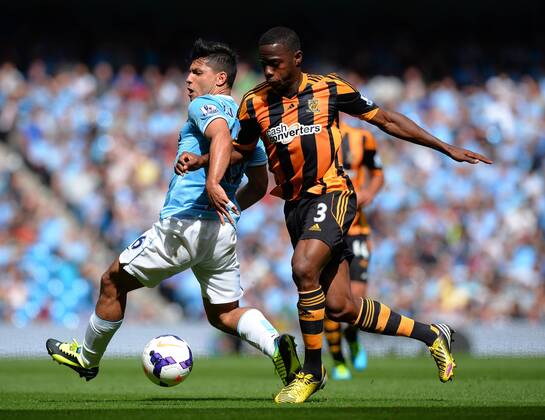 Sergio Kun Agüero of Manchester City is knocked off the ball by Maynor Figueroa of Hull City - Barclays Premier League - Manchester City vs Hull City - Etihad Stadium - Manchester - England - 31 08 13 - EDITORIAL USE ONLY. No use with unauthorised audio, video, data, fixture lists, club league logos or live services. Online in-match use limited to 120 images, no video emulation. No use in betting, games or single club league player publications.