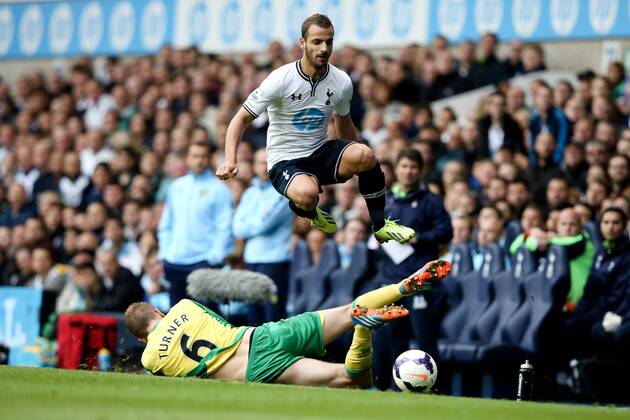 Tottenham s Roberto Soldado jumps a tackle from Norwich City s Michael Turner - Tottenham Hotspur vs Norwich City - Premier League 2013 14 - White Hart Lane - London - 14th September 2013 - EDITORIAL USE ONLY. No use with unauthorised audio, video, data, fixture lists, club league logos or live services. Online in-match use limited to 120 images, no video emulation. No use in betting, games or single club league player publications.