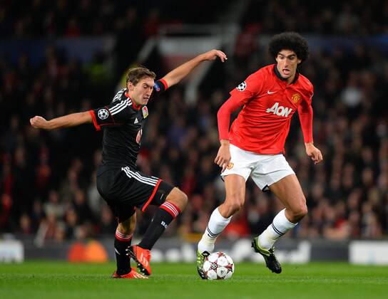 Stefan Reinartz of Bayer Leverkusen tackles Mauroane Fellaini of Manchester United - UEFA Champions League Group A - Manchester Utd vs Bayer Leverkusen - Old Trafford Stadium - Manchester - 17 09 13 - Picture Simon Bellis Sportimage EDITORIAL USE ONLY. No use with unauthorised audio, video, data, fixture lists, club league logos or live services. Online in-match use limited to 120 images, no video emulation. No use in betting, games or single club league player publications.