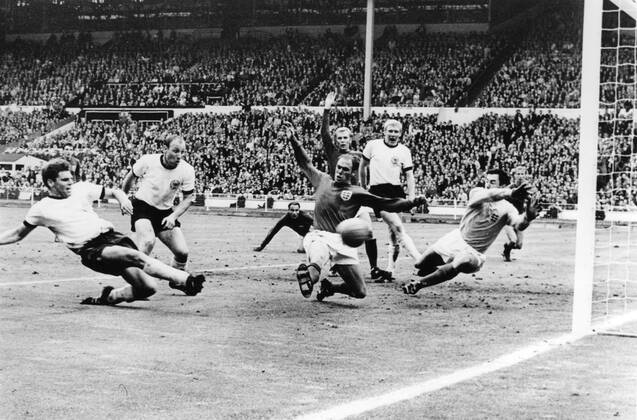 Just a few seconds to go in the World Cup Final and West Gemany s Wolfgang Weber side-foots the ball past England s Gordon Banks, Goalkeeper, to snatch the eualiserat Wembley Stadium July 30th 1966. In the extra time that followed, England scored twice to end up 4-2 winners. Also in this picture are West German captain Uwe Seeler (second left) England s Ramon Wilson (dark shirt); behind Wilson is Moore, the England captain; Schnellinger (white shirt) and in the background extreme right, Jackie Charlton. Just seen in hte background centre, is George Cohen, the other England pull back. 30th July 1966  UnitedArchives01028390