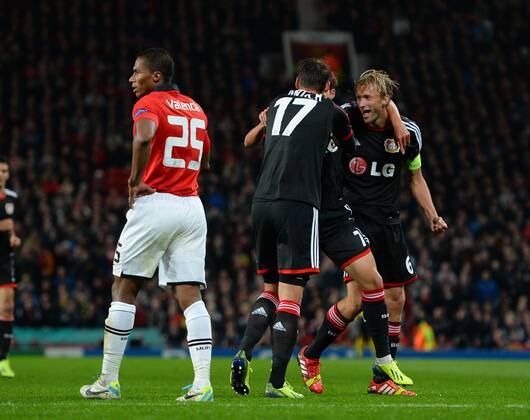 Simon Rolfes of Bayer 04 Leverkusen (r) is mobbed after scoring - UEFA Champions League Group A - Manchester United (ManU) vs Bayer 04 Leverkusen - Old Trafford Stadium - Manchester - 17 09 13 - Picture SimonxBellis Sportimage EDITORIAL USE ONLY. No use with unauthorised audio, video, data, fixture lists, club league logos or live services. Online in-match use limited to 120 images, no video emulation. No use in betting, games or single club league player publications.