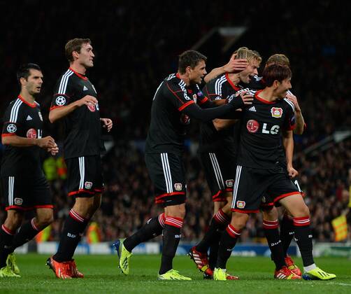 Simon Rolfes of Bayer 04 Leverkusen is mobbed after scoring - UEFA Champions League Group A - Manchester United (ManU) vs Bayer 04 Leverkusen - Old Trafford Stadium - Manchester - 17 09 13 - Picture SimonxBellis Sportimage EDITORIAL USE ONLY. No use with unauthorised audio, video, data, fixture lists, club league logos or live services. Online in-match use limited to 120 images, no video emulation. No use in betting, games or single club league player publications.