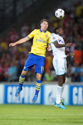 Arsenal s Aaron Ramsey and Alaixys Ramao of Marseille compete for a header - Olympique de Marseille vs. Arsenal FC London - UEFA Champion s League - Stade Velodrome - Marseille, France - 18 09 2013 Pic Philip Oldham Sportimage EDITORIAL USE ONLY. No use with unauthorised audio, video, data, fixture lists, club league logos or live services. Online in-match use limited to 120 images, no video emulation. No use in betting, games or single club league player publications.