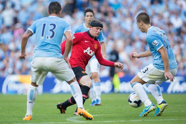 Wayne Rooney of Manchester United struggles to pass the City defence - Manchester City vs Manchester United - Barclay s Premier League - Etihad Stadium - Manchester - 22 09 2013 Pic Philip Oldham Sportimage EDITORIAL USE ONLY. No use with unauthorised audio, video, data, fixture lists, club league logos or live services. Online in-match use limited to 120 images, no video emulation. No use in betting, games or single club league player publications.