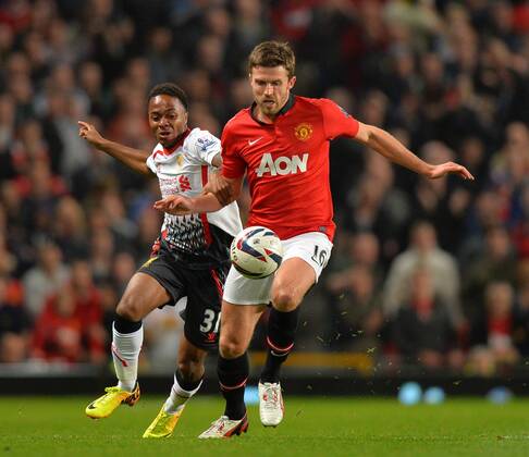 Raheem Sterling of Liverpool tussles with Michael Carrick of Manchester United - Capital One Cup - Third Round - Manchester United, ManU - FC Liverpool. Old Trafford Stadium - Manchester - 25 09 13 - PicturexSimon BellisxSportimage EDITORIAL USE ONLY. No use with unauthorised audio, video, data, fixture lists, club league logos or live services. Online in-match use limited to 120 images, no video emulation. No use in betting, games or single club league player publications.