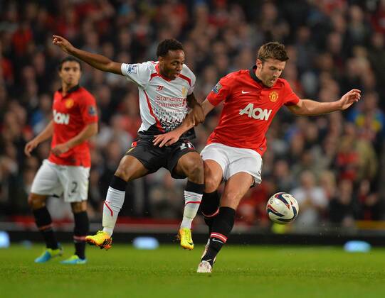 Raheem Sterling of Liverpool tussles with Michael Carrick of Manchester United - Capital One Cup - Third Round - Manchester United, ManU - FC Liverpool. Old Trafford Stadium - Manchester - 25 09 13 - PicturexSimon BellisxSportimage EDITORIAL USE ONLY. No use with unauthorised audio, video, data, fixture lists, club league logos or live services. Online in-match use limited to 120 images, no video emulation. No use in betting, games or single club league player publications.