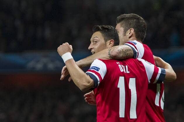 01.10.2013 London, England. Arsenal forward Olivier Giroud (12) celebrates his goal with teammate midfielder Mesut Ã–zil (11) during the UEFA Champions League Group Stage fixture between Arsenal and SSC Napoli from the Emirates Stadium xDavidxFearnx  ActionPlus20148816