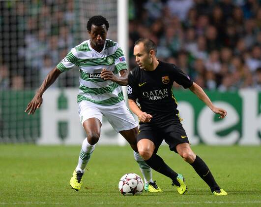 Efe Ambrose of Celtic holds up Andres Iniesta of Barcelona - UEFA Champions League Group H - Celtic vs Barcelona - Celtic Park Stadium - Glasgow - Scotland - 01 10 13 - Picture Simon Bellis Sportimage EDITORIAL USE ONLY. No use with unauthorised audio, video, data, fixture lists, club league logos or live services. Online in-match use limited to 120 images, no video emulation. No use in betting, games or single club league player publications.