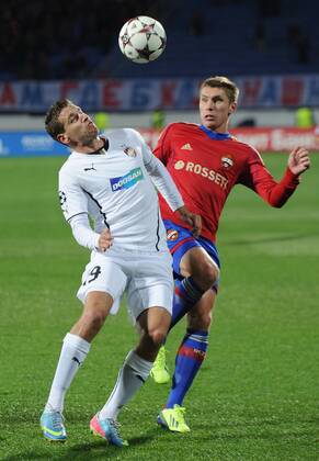 ITAR-TASS: ST PETERSBURG, RUSSIA. OCTOBER 2, 2013. Viktoria Plzen s Jan Kovarik (white), CSKA s Kirill Nababkin (red) in the UEFA Champions League 2013 2014 Group D Round 2 CSKA Moscow vs Viktoria Plzen game at Petrovsky Stadium.  premiumd RE12B234