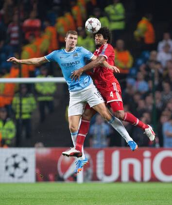 Edin Dzeko of Manchester City and Dante of Munich battle in the air - Manchester City vs. FC Bayern Munich - UEFA Champion s League - Etihad Stadium - Manchester - 02 19 2013 Pic Philip Oldham Sportimage EDITORIAL USE ONLY. No use with unauthorised audio, video, data, fixture lists, club league logos or live services. Online in-match use limited to 120 images, no video emulation. No use in betting, games or single club league player publications.