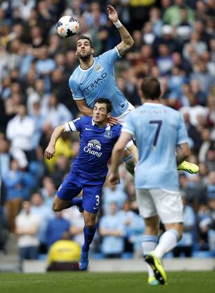 MANCHESTER, Alvaro Negredo (Top) of Manchester City vies with Leighton Baines of Everton during the Barclays Premier League match between Manchester City and Everton at Etihad Stadium in Manchester, Britain on Oct. 5, 2013. (Xinhua Wang Lili) FOR EDITORIAL USE ONLY. NOT FOR SALE FOR MARKETING OR ADVERTISING CAMPAIGNS. NO USE WITH UNAUTHORIZED AUDIO, VIDEO, DATA, FIXTURE LISTS, CLUB LEAGUE LOGOS OR LIVE SERVICES. ONLINE IN-MATCH USE LIMITED TO 45 IMAGES, NO VIDEO EMULATION. NO USE IN BETTING, GAMES OR SINGLE CLUB LEAGUE PLAYER PUBLICATIONS. (SP)BRITAIN-MANCHESTER-SOCCER-PREMIER LEAGUE-MAN CITY VS EVERTON 