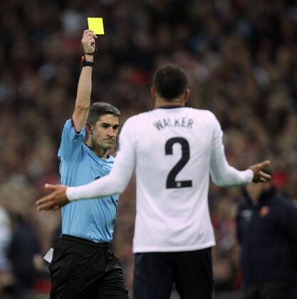 England v Montenegro - World Cup Qualifier . . Wembley, London, UK . . 11.10.2013 Referee Alberto Undiano Mallenco gives Kyle Walker (E) a yellow card.