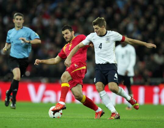 England v Montenegro - World Cup Qualifier . . Wembley, London, UK . . 11.10.2013 Simon Vukcevic (M) Steven Gerrard (E)