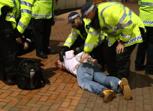 Poland - World Cup Qualifier . . Wembley, London . . 15.10.2013 A Polish fan is restrained by police outside Wembley Stadium.
