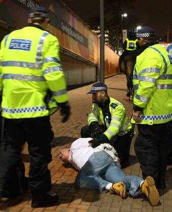 Poland - World Cup Qualifier . . Wembley, London . . 15.10.2013 A Polish fan is restrained by police outside Wembley Stadium.