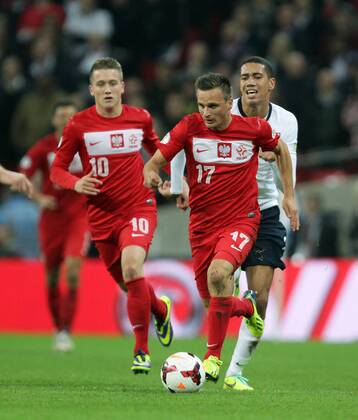 England v Poland - World Cup Qualifier . . Wembley, London, UK . . 15.10.2013 Slawomir Peszko (P) with Chris Smalling (E) chasing.