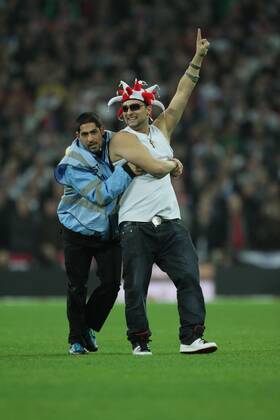 Poland - World Cup Qualifier . . Wembley, London . . 15.10.2013 A Poland fan enjoys himself on the pitch after invading.