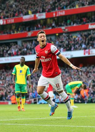 Arsenal s Mesut Ozil celebrates scoring his sides second goal Arsenal FC London v Norwich City - Barclays Premier League - Emirates Stadium - London - England -19 10 2013 - EDITORIAL USE ONLY. No use with unauthorised audio, video, data, fixture lists, club league logos or live services. Online in-match use limited to 120 images, no video emulation. No use in betting, games or single club league player publications.