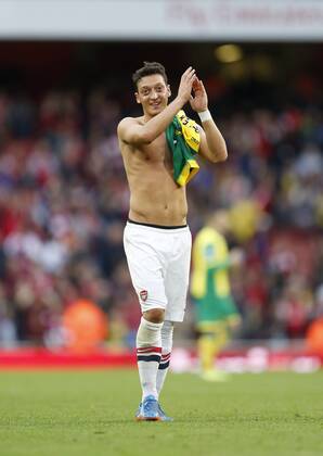 Arsenal s Mesut Ozil celebrates at the final whistle Arsenal FC London v Norwich City - Barclays Premier League - Emirates Stadium - London - England -19 10 2013 - EDITORIAL USE ONLY. No use with unauthorised audio, video, data, fixture lists, club league logos or live services. Online in-match use limited to 120 images, no video emulation. No use in betting, games or single club league player publications.