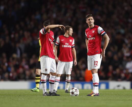 Arsenal s Mesut Ozil and Olivier Giroud look on dejected after going 1-0 down Arsenal v Dortmund - UEFA Champions League - the Emirates - London - England -22 10 2013 - Pic David Klein Sportimage EDITORIAL USE ONLY. No use with unauthorised audio, video, data, fixture lists, club league logos or live services. Online in-match use limited to 120 images, no video emulation. No use in betting, games or single club league player publications.