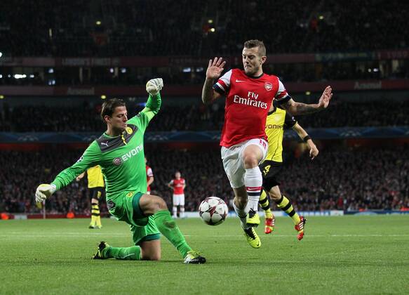 Arsenal s Jack Wilshere tussles with Dortmund s Roman Weidenfeller Arsenal v Dortmund - UEFA Champions League - the Emirates - London - England -22 10 2013 - Pic David Klein Sportimage EDITORIAL USE ONLY. No use with unauthorised audio, video, data, fixture lists, club league logos or live services. Online in-match use limited to 120 images, no video emulation. No use in betting, games or single club league player publications.